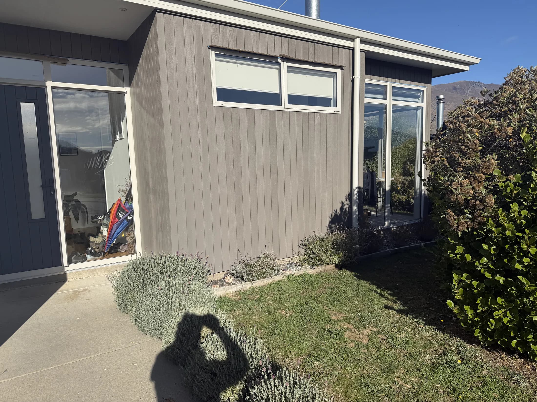 Weathered grey cedar cladding on a Wanaka home before restoration