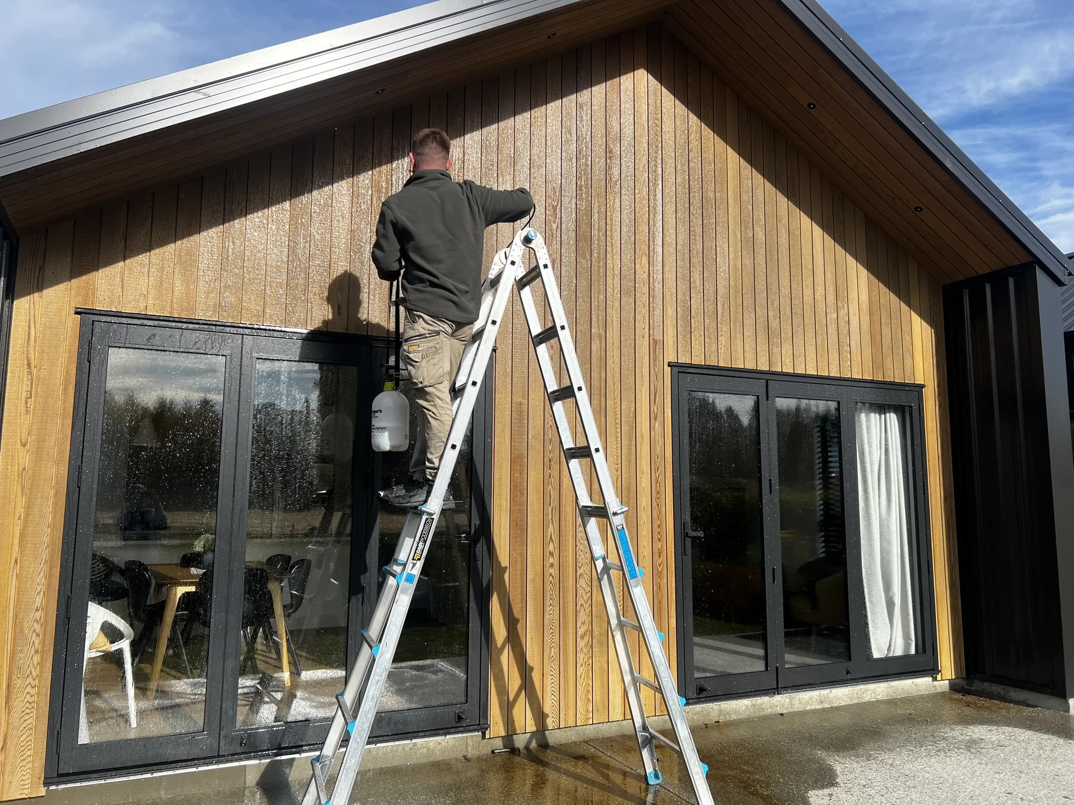 Chemical wash preparation on cedar cladding in Northlake, Wanaka
